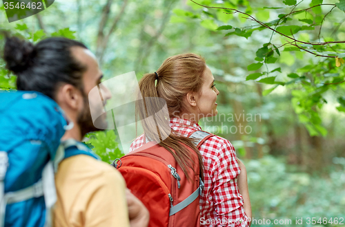 Image of group of smiling friends with backpacks hiking