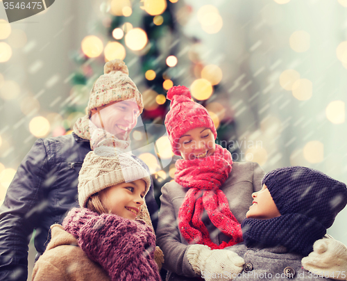 Image of happy family in winter clothes outdoors