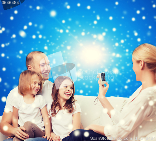Image of happy family with camera at home