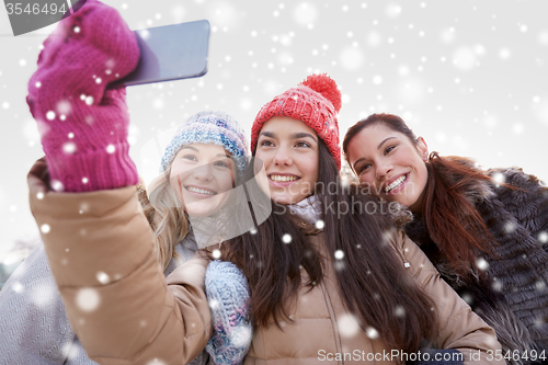 Image of happy teenage girls taking selfie with smartphone