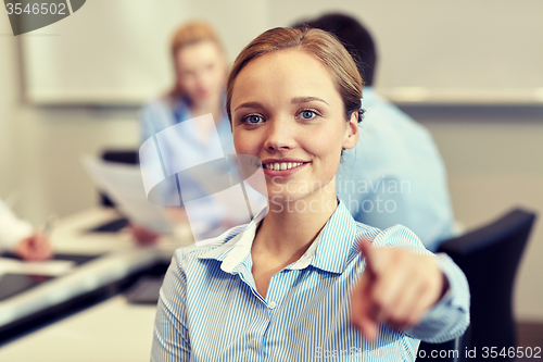 Image of smiling businesswoman pointing finger on you