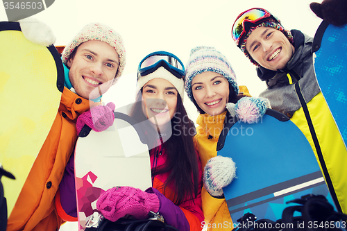 Image of happy friends with snowboards