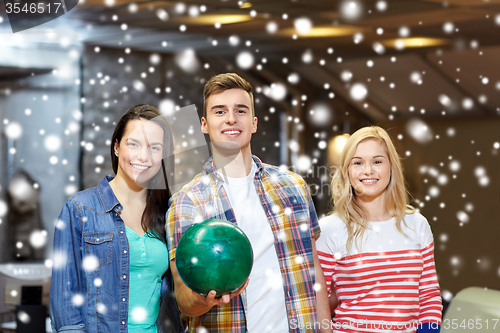 Image of happy friends in bowling club at winter season