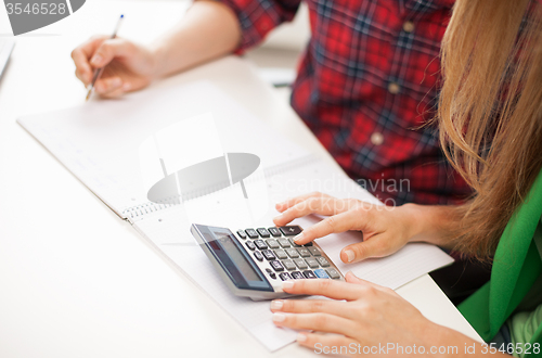 Image of students with notebook and calculator at school