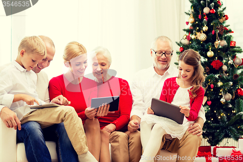 Image of smiling family with tablet pc computers at home