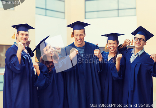 Image of group of smiling students in mortarboards