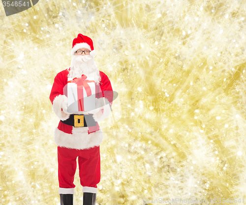 Image of man in costume of santa claus with gift box