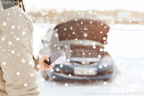 Image of closeup of man with broken car and smartphone