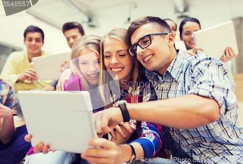 Image of group of smiling students with tablet pc