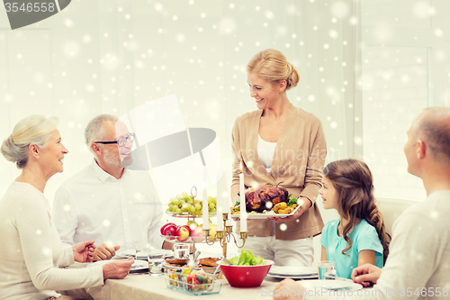 Image of smiling family having holiday dinner at home