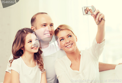 Image of happy family with little girl making self portrait