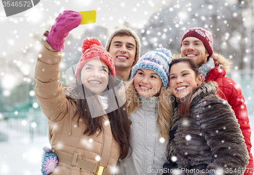 Image of happy friends taking selfie with smartphone