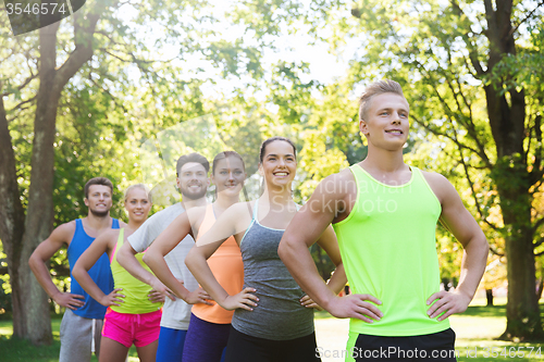 Image of group of happy friends or sportsmen outdoors