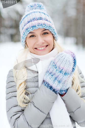 Image of smiling young woman in winter forest