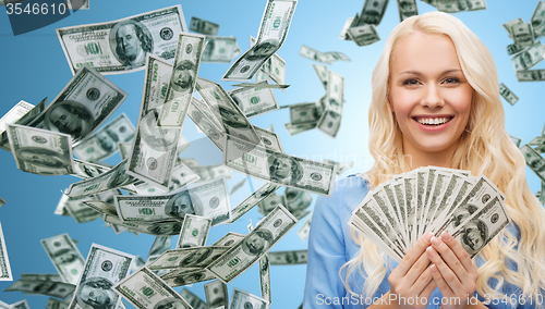 Image of smiling businesswoman with dollar cash money