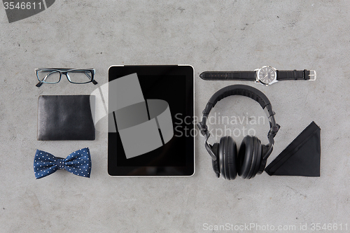 Image of tablet pc, headphones with hipster personal stuff