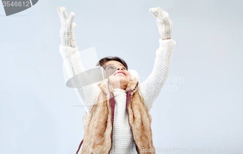 Image of happy little girl wearing earmuffs