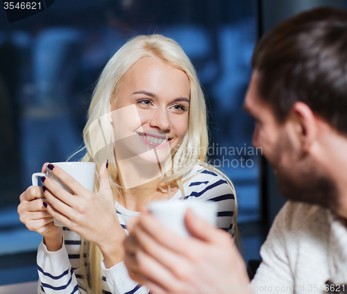 Image of happy couple meeting and drinking tea or coffee