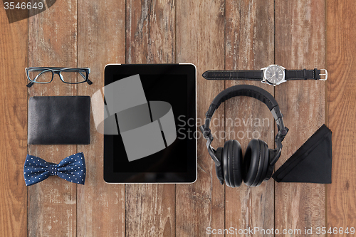 Image of tablet pc, headphones with hipster personal stuff