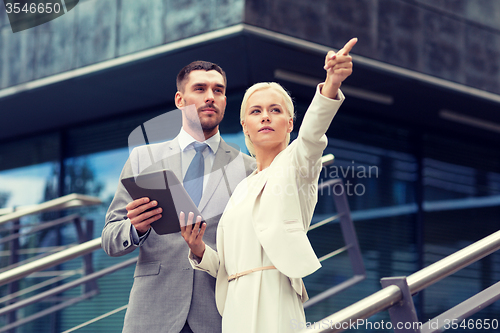 Image of serious businessmen with tablet pc outdoors