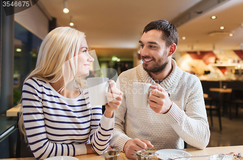 Image of happy couple meeting and drinking tea or coffee