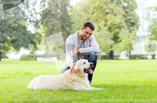 Image of happy man with labrador dog walking in city