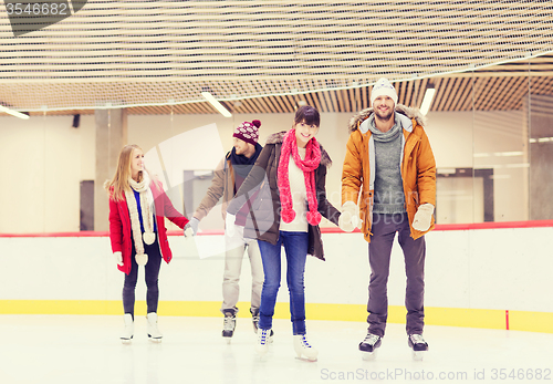 Image of happy friends on skating rink