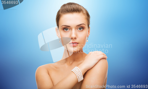 Image of beautiful woman with pearl earrings and bracelet