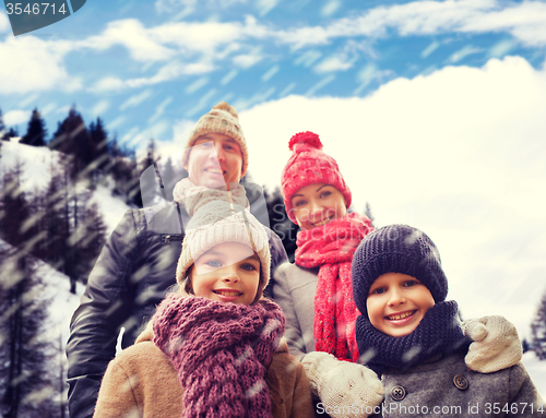 Image of happy family in winter clothes outdoors