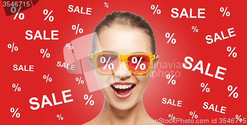 Image of happy teenage girl in shades with sale signs