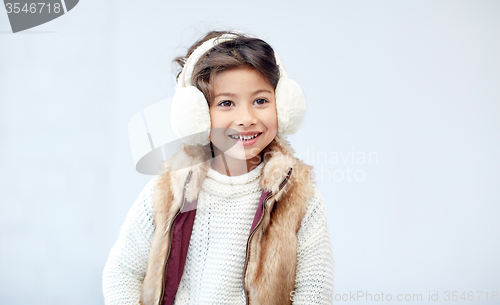 Image of happy little girl wearing earmuffs