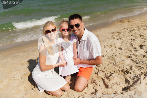 Image of happy family in sunglasses on summer beach