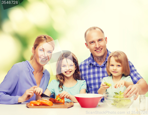 Image of happy family with two kids making dinner at home