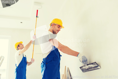 Image of group of builders with tools indoors