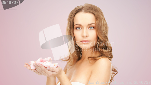 Image of beautiful smiling young woman with flower petals