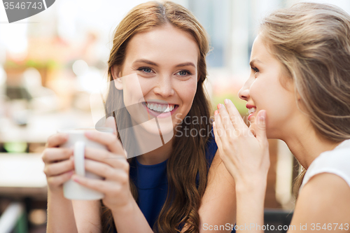 Image of young women drinking coffee and talking at cafe