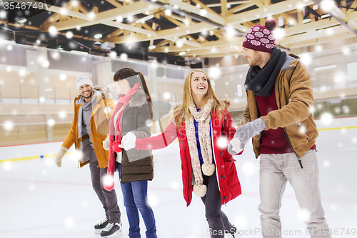 Image of happy friends on skating rink