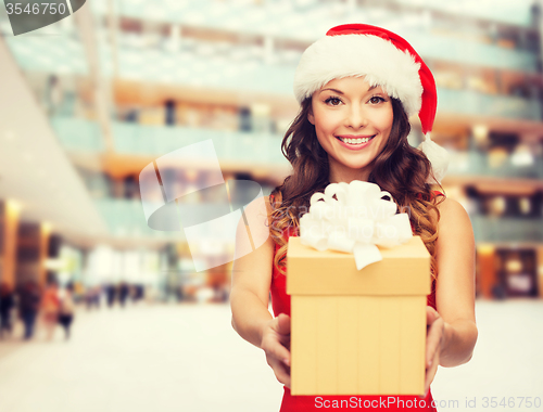 Image of smiling woman in red dress with gift box