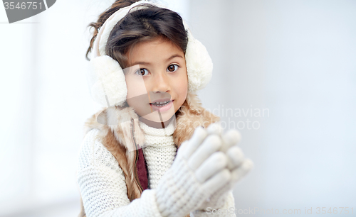 Image of happy little girl wearing earmuffs