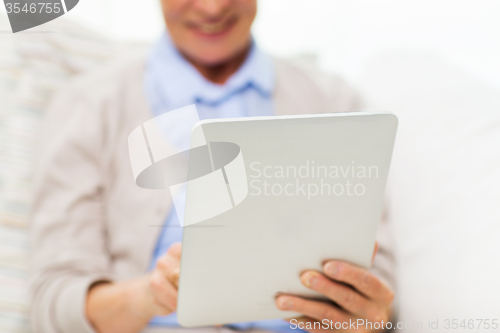 Image of close up of senior woman with tablet pc at home