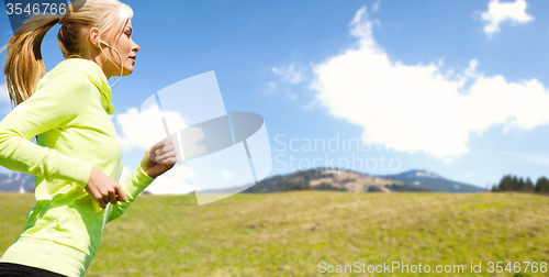 Image of happy sporty woman running or jogging outdoors