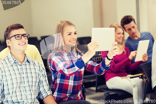 Image of group of smiling students with tablet pc