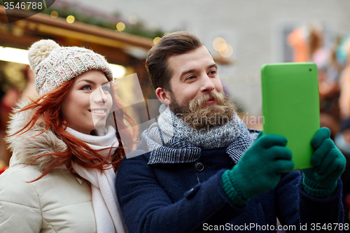 Image of couple taking selfie with tablet pc in old town