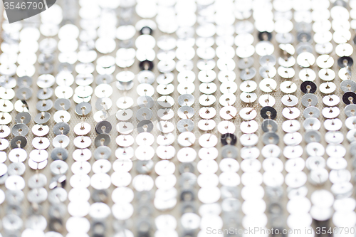 Image of close up of silver sequined textile texture