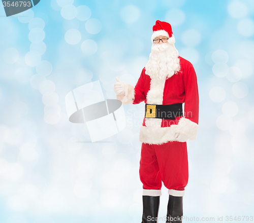 Image of man in costume of santa claus showing thumbs up