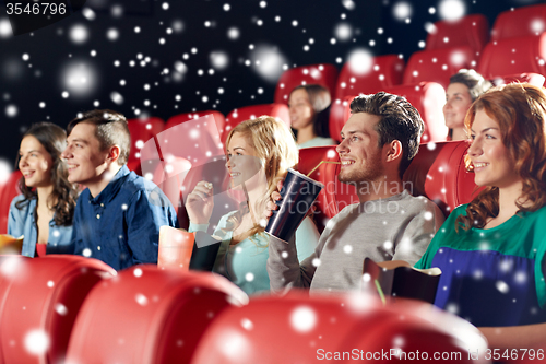 Image of happy friends with popcorn and drinks in cinema