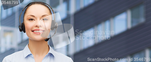 Image of helpline operator in headset over business center