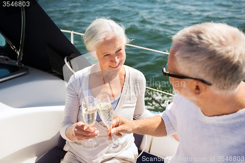 Image of senior couple clinking glasses on boat or yacht