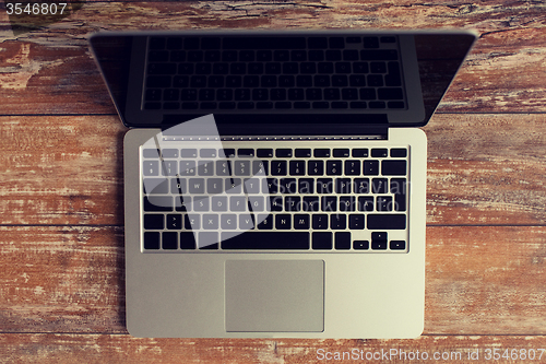 Image of laptop computer with black blank screen on table