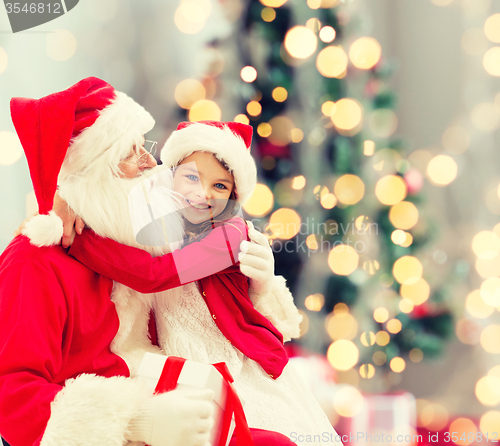 Image of smiling little girl with santa claus